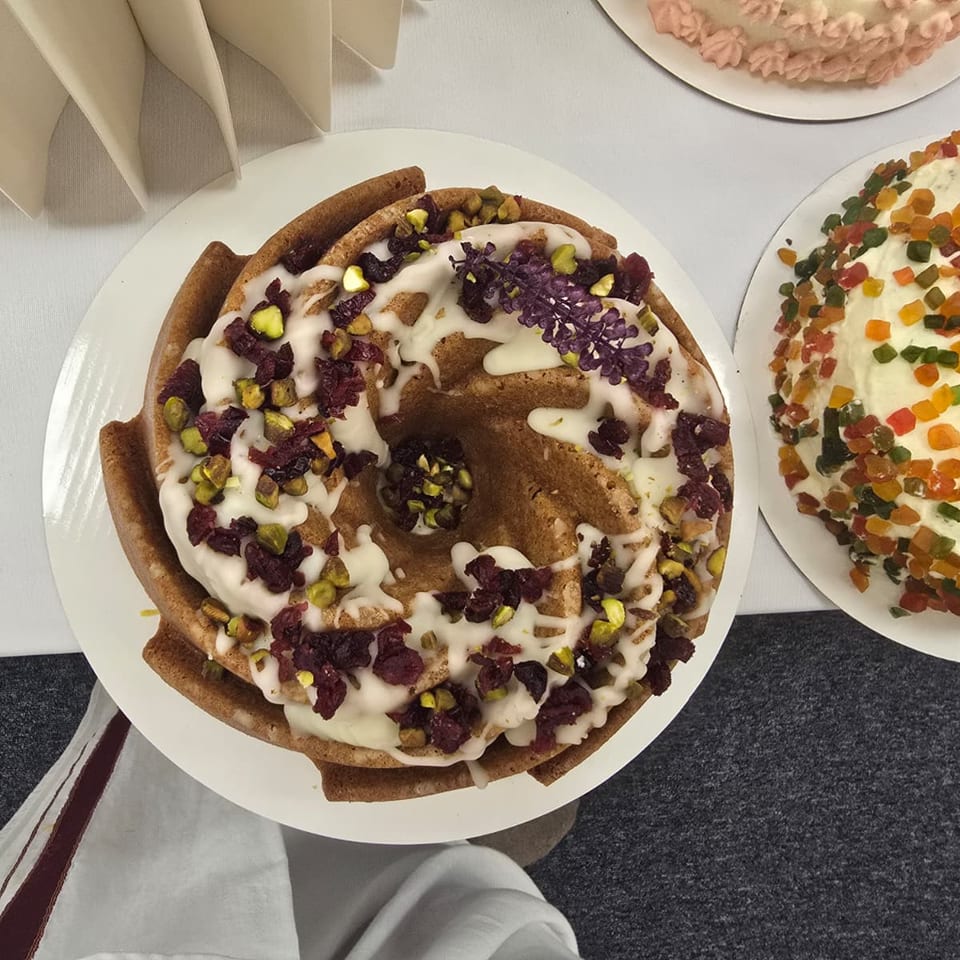 Ring-shaped cake with icing and colorful toppings